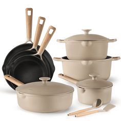 an assortment of pots and pans with wooden utensils