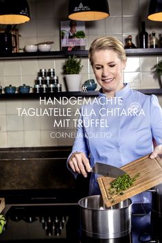 a woman in a blue shirt is holding a wooden cutting board and potted plant