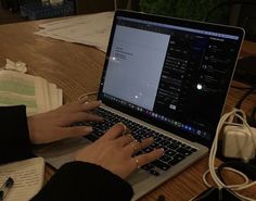 a woman is typing on her laptop computer