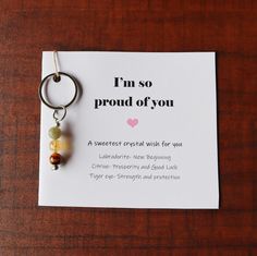 a card with a keychain that says i'm so proud of you