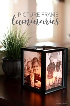 an old photo frame sitting on top of a table next to a potted plant