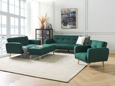 a living room with green couches and white rugs on the wooden flooring