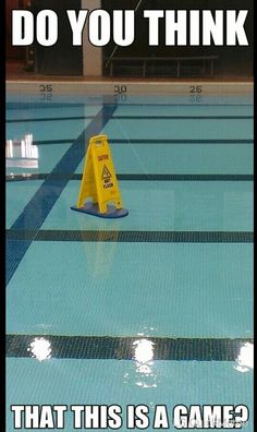 an empty swimming pool with blue water and yellow caution signs