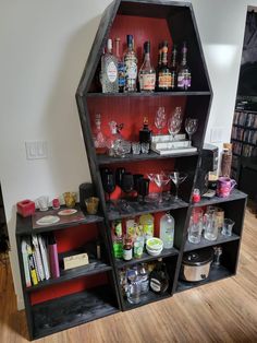 the shelves are filled with liquor bottles and glasses