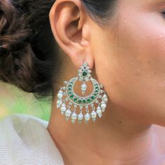 Introducing our exquisite Emerald Chand Bali antique earrings, each a masterpiece meticulously handcrafted in 92.5% sterling silver. These earrings are more than mere adornments; they are instant charmers, designed to make a striking statement. Elevate your style and infuse a dose of drama into your ensemble with these enchanting Emerald Chand Bali earrings. Specifics : Stone : Emerald/ Pearl Stone Color : Green White Stone Shape : Round, Oval Pair Weight :38 Gram Approx Material : 925 Sterling Emerald Earrings Wedding, Chand Bali Earrings, Wedding Jewelry Indian, Chand Bali, Bali Earrings, Chandbali Earrings, Pearl Stone, Traditional Earrings, Jewelry Indian