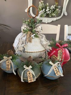 several ornaments are sitting on a table with ribbon around them and ribbons hanging from the top