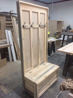 a wooden bench sitting inside of a room next to other woodworking tools and supplies