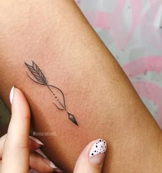 a woman's arm with a small tattoo on the left side of her body