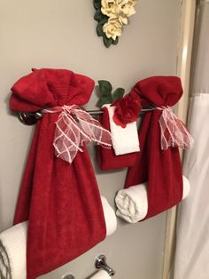 red towels hanging on a towel rack in a bathroom