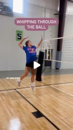 a woman jumping up in the air to hit a volleyball