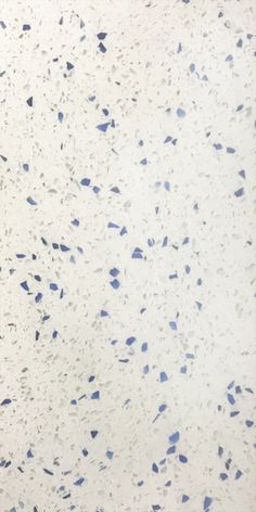 an image of blue and white speckles on the surface of a tile wall