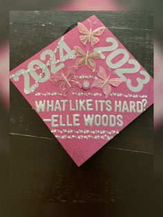 a pink graduation cap that says what like it's hard? ellen woods 2013