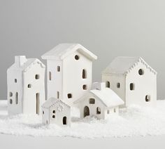 small white houses in the snow on a gray background