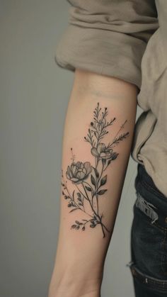 a woman's arm with a flower tattoo on the left side of her arm