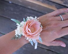 a woman's hand holding onto a wrist with flowers on it