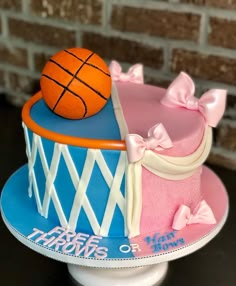 a birthday cake with a basketball on top and bowtie around the edges, sitting on a pedestal