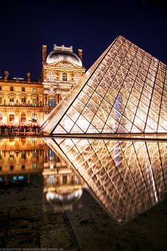 the glass pyramid is lit up at night