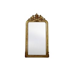 an ornate gold framed mirror against a white wall