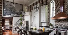 a large kitchen with an island in the middle and lots of counter space next to it