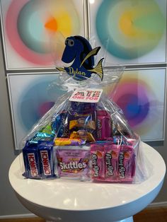 a basket filled with candy and snacks on top of a table