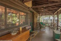 a porch with chairs and tables on it