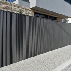 a black metal fence next to a building