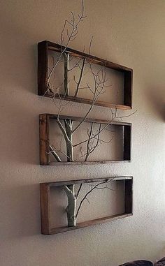 two wooden shelves with trees in them are hanging on the wall next to a bed