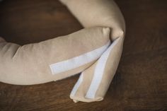 a close up of a cloth wrapped around a pillow on top of a wooden table