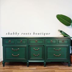 a green dresser with the words shabby roots boutique written on it's side