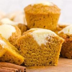 muffins with icing and cinnamon on a cutting board