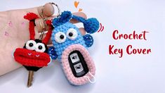 a crochet key cover is being held by someone's hand