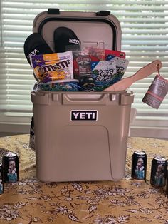 the yeti cooler is full of beer, snacks and other things to pack into it