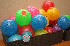 a basket filled with lots of different colored balls and numbers on top of each other