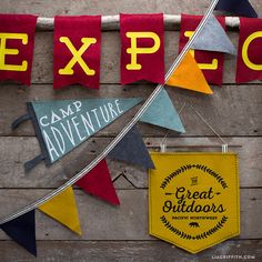 there are some signs on the wall that say camp adventure and have pennants hanging from them