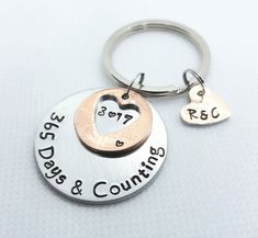 two personalized keychains with hearts and names on them, one is for dad and the other is for daughter