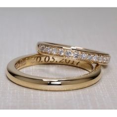 two gold wedding bands with diamonds on them