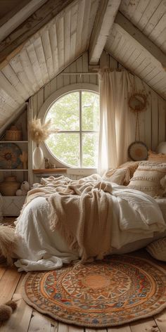 an attic bedroom with a round window and rug