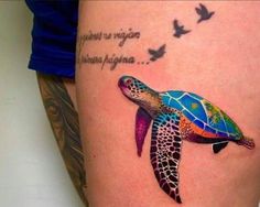 a colorful turtle tattoo on the thigh