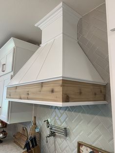 a stove top oven sitting inside of a kitchen next to a wall mounted range hood