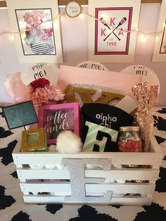 a white crate filled with assorted items on top of a bed