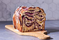 a loaf of blueberry swirl bread on a cutting board