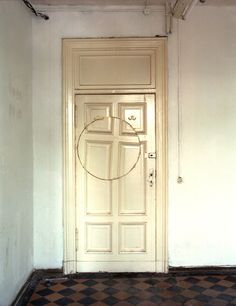 an empty room with a door and checkered floor