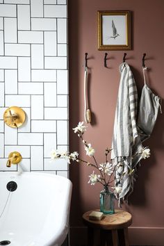 a bath room with a sink and a towel hanging on the wall next to it