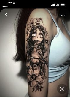 a woman's arm with a tattoo on it that has a girl holding a knife