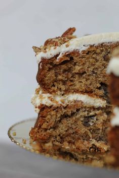 a slice of carrot cake with cream frosting on a plate