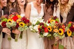 a group of women standing next to each other holding bouquets