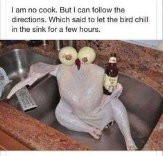 a turkey sitting in a kitchen sink with two bottles of beer on it's head