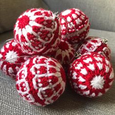 several red and white balls sitting on top of a couch