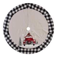 a round christmas tree skirt with a red truck on it