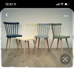 three chairs sitting side by side on top of a wooden floor